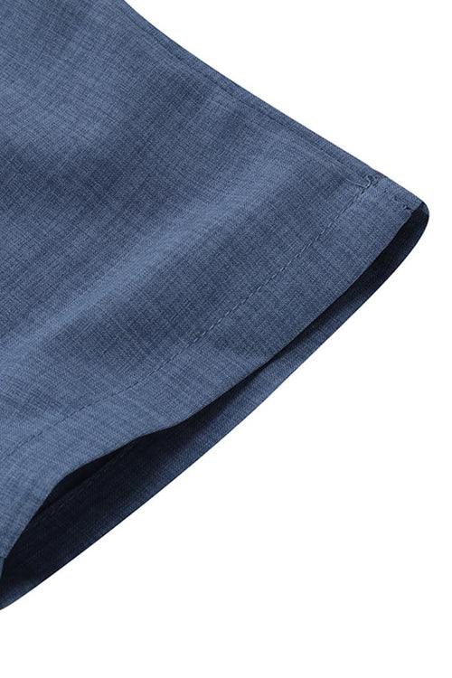 Close-up of blue high-waist wrapped pants fabric and hem detail