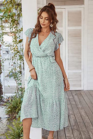 Woman wearing Elegant Blossoms Boho Maxi Dress with floral print and ruffled sleeves on wooden porch