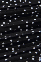 Close-up of black pleated fabric with white polka dots from Effortlessly Chic Polka Dot Pleated Skirt Set
