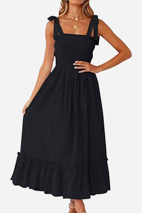 Black Sunkissed Spaghetti Boho Dress with adjustable tie-up straps and flowy high-waist silhouette for summer comfort and style