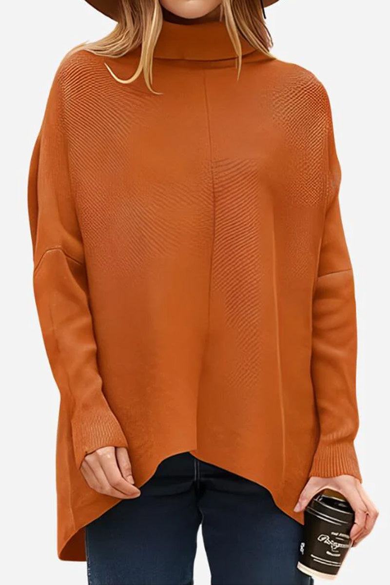 Woman wearing a burnt orange cozy oversized knit pullover with long sleeves and a relaxed fit holding a coffee cup