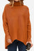 Woman wearing a burnt orange cozy oversized knit pullover with long sleeves and a relaxed fit holding a coffee cup