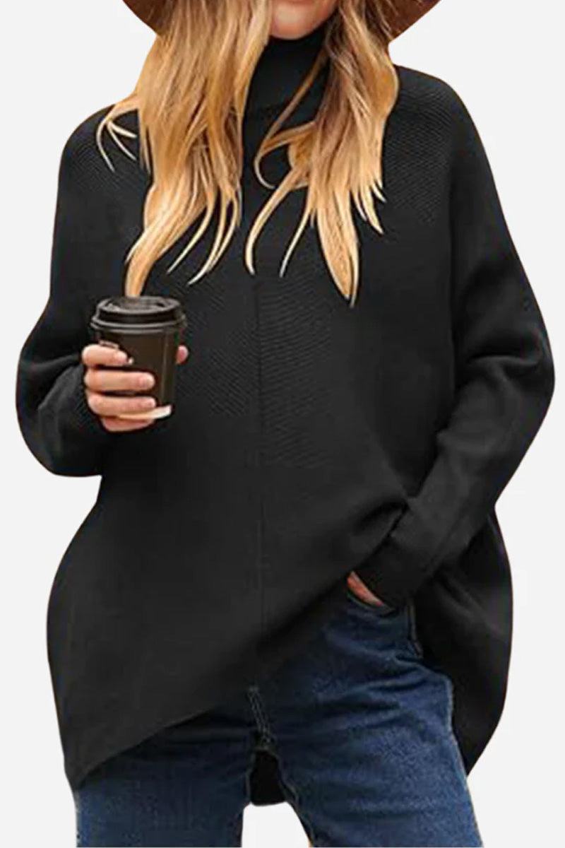 Woman wearing cozy oversized black knit pullover with jeans holding coffee cup