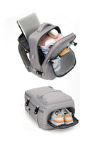 Chic Wanderlust Waterproof Backpack in gray with spacious compartments for laptop, headphones, camera, and separate shoe storage compartment.