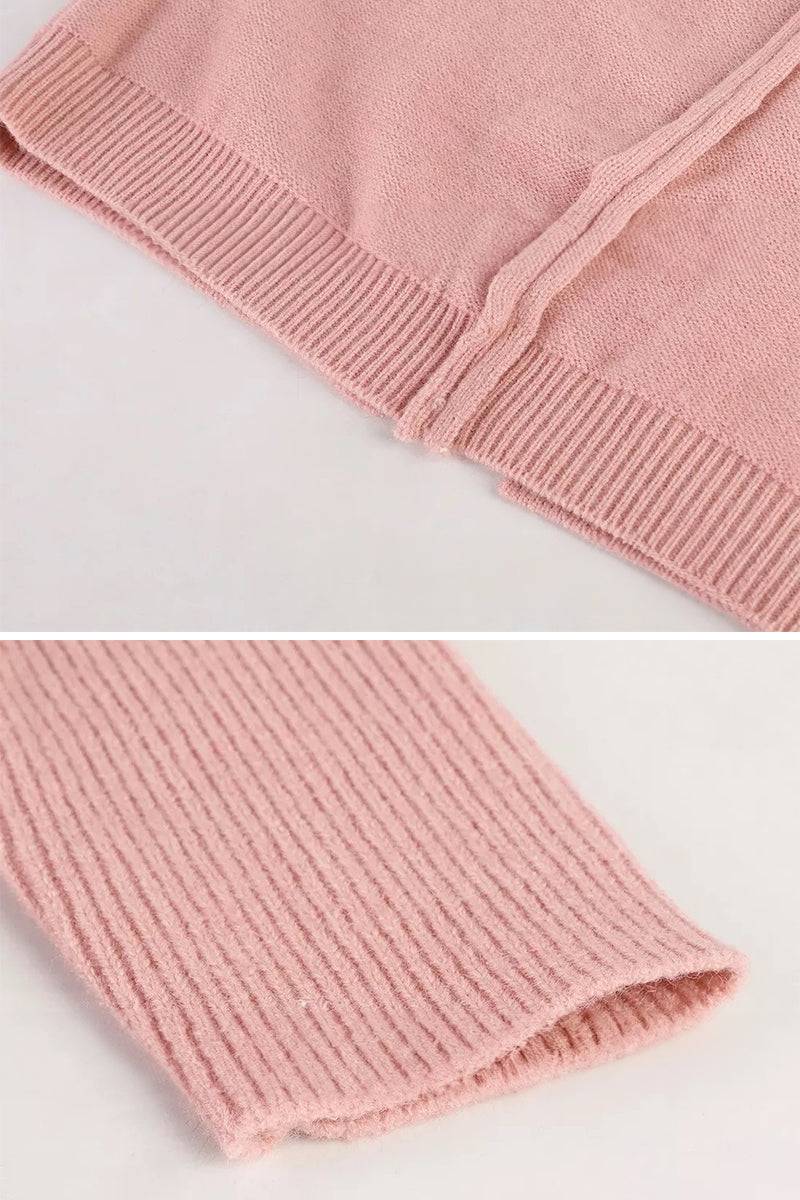 Close-up of soft pink warm oversized hooded cardigan fabric and ribbed cuffs detail