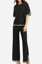 Black short sleeved relaxed fit lounge two-piece set with white trim on sleeves, hem, and pant legs