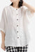 Relaxed loose breathable white linen blouse with button front and three-quarter sleeves