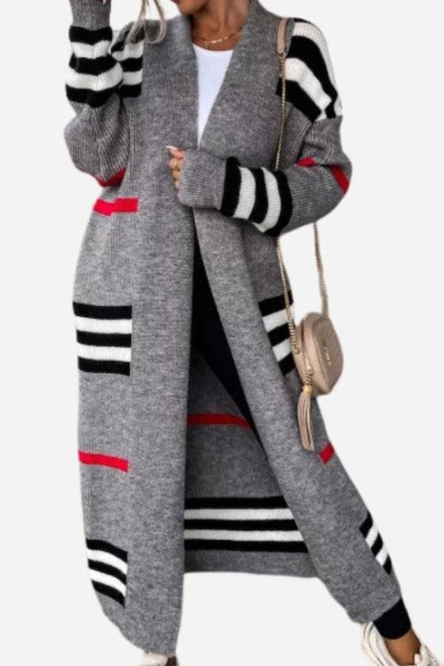 Cozy striped long knitted cardigan with oversized fit and red, black, white stripes on grey fabric