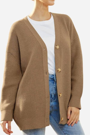 Relaxed fit oversized brown knitwear cardigan with button-down front worn over white t-shirt and blue jeans