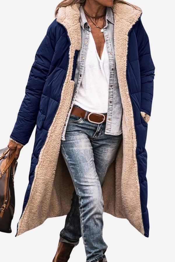 Woman wearing navy sherpa-lined hooded teddy coat with plush beige lining and casual jeans