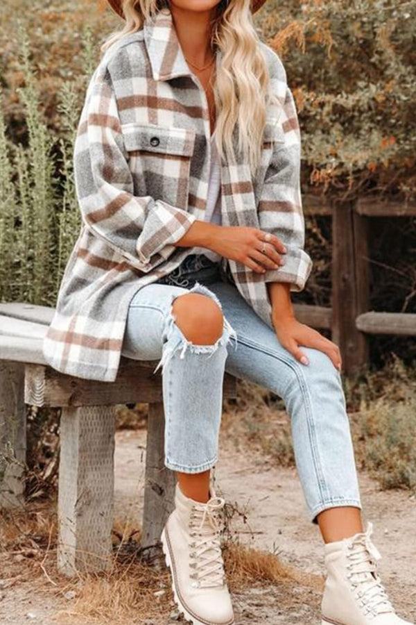 Woman wearing comfy flannel classic button-down shirt with plaid pattern, styled with ripped jeans and beige boots outdoors