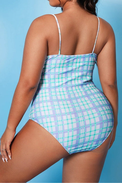 Curvy Comfort Plus Size one-piece swimsuit with pastel plaid pattern and adjustable thin straps on plus-size model against blue background
