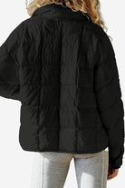 Lightweight puffer travel jacket packed compactly for versatile, warm, and stylish travel use