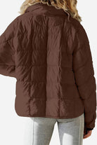 back view of lightweight puffer travel jacket in brown on model