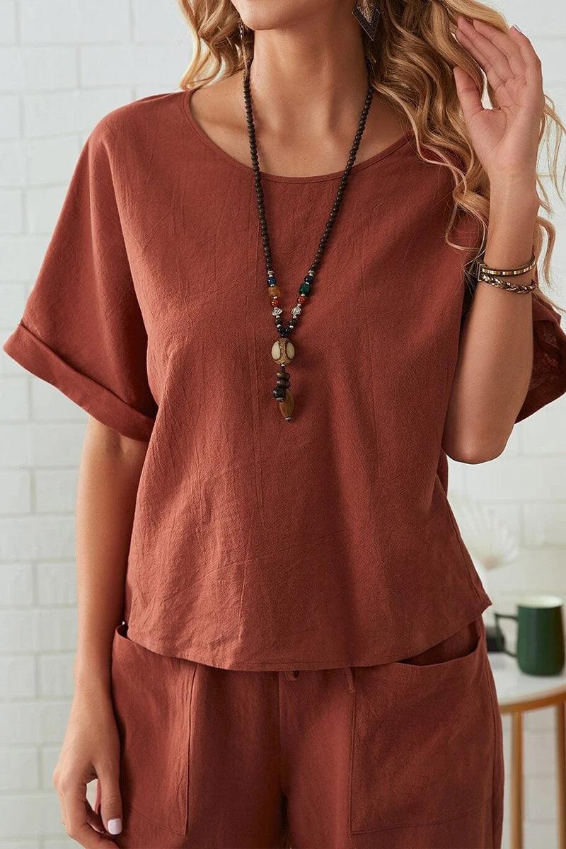 Women's rolled cuff top and patch pocket pants set in rust color, relaxed fit, breathable cotton blend fabric.