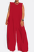 Red sleeveless wide-leg jumpsuit with a relaxed fit and sharp shoulder details, styled with gold accessories.