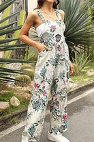 woman wearing floral print Bohemian Fantasy Overalls with square neck and wide legs outdoors