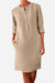 Beige cotton dress with half-button front, rolled ¾ sleeves, knee-length, and practical pockets, suitable for summer and casual wear.