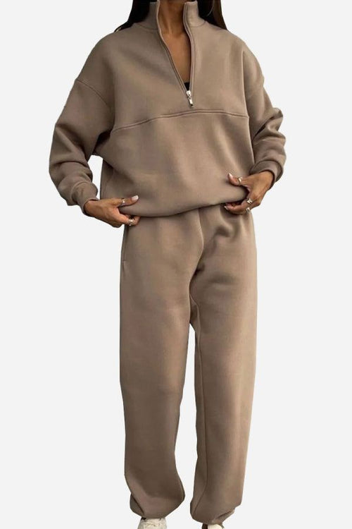 Woman wearing a brown cotton-blended two-piece tracksuit with high collar and zipper front