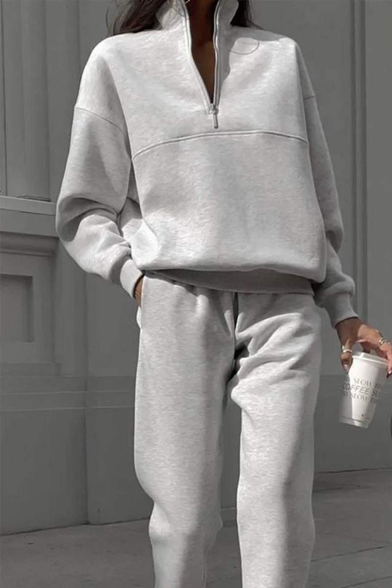 Grey cotton-blended two-piece tracksuit with high collar and deep zipper, styled for casual comfort and outside wear.