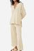 Multi-weather comfort two-piece oversized beige knit set with relaxed fit top and wide-leg pants.