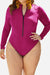 Zip front long sleeve one-piece swimsuit in deep rose red with high-leg cut and front zipper closure.