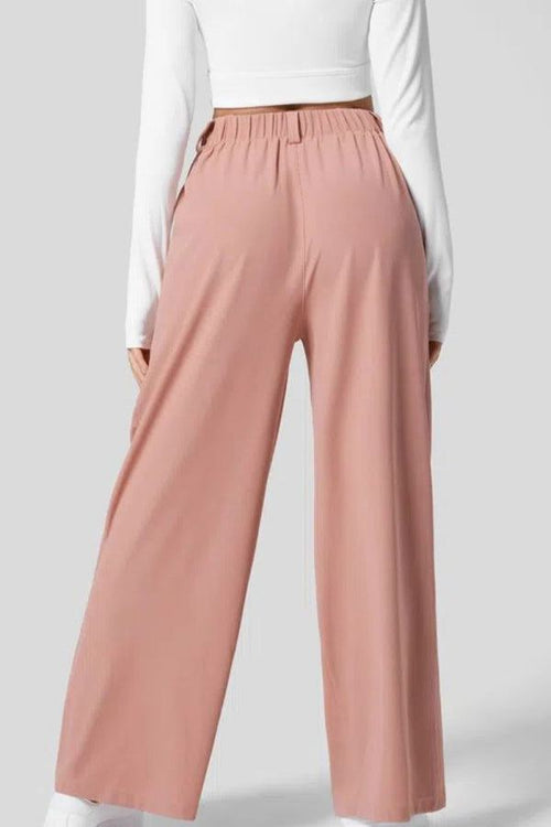 Back view of pink high-waisted plicated wide leg waffle pants on model