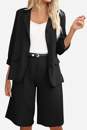 Black blazer and high-waisted shorts two-piece set with white top and belt, stylish and polished women's outfit