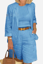 Blue blazer and high-waisted shorts two-piece set with rolled-up sleeves and matching top.