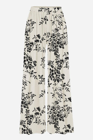 Stretchy wide-leg pants with black floral print on white fabric and elastic waistband for all-day comfort