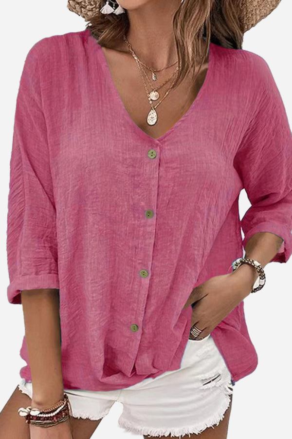 pink button front tunic with rolled sleeves and v-neck neckline paired with white shorts