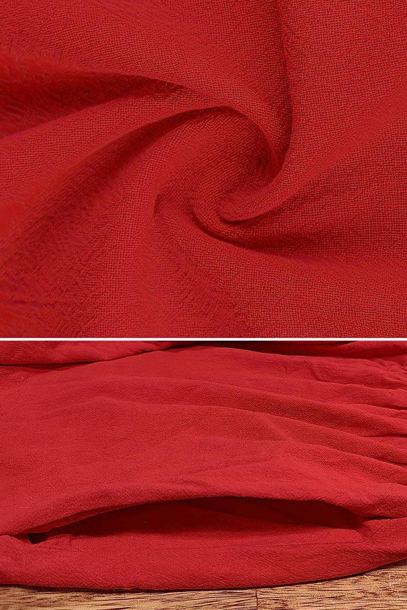 Red textured fabric close-up and pocket detail of capped-sleeve voluminous pleated midi dress