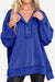 Blue oversized urban sweatshirt with slouchy sleeves and buttoned Henley neckline on model