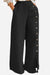 Black wide leg pants with side buttons and split seam detail, high-waisted breathable cotton blend trousers for a sophisticated maritime chic look.