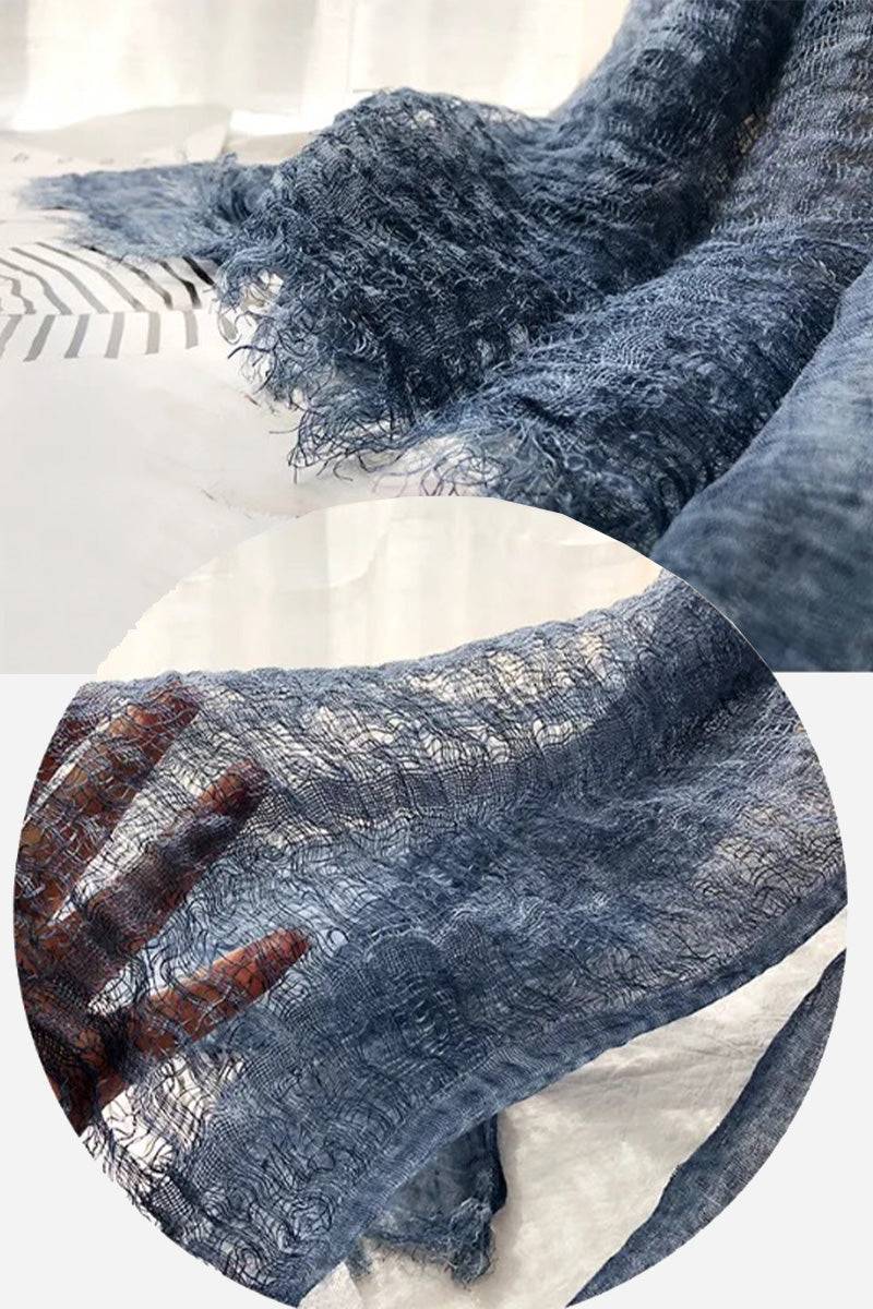 Blue lightweight linen scarf with frayed edges showcasing breathable, airy texture and natural fabric detail.
