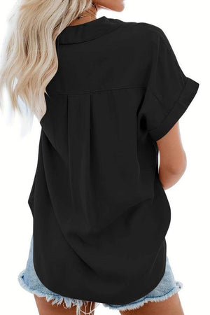 black V-neck collared button blouse with rolled short sleeves worn with denim shorts, back view