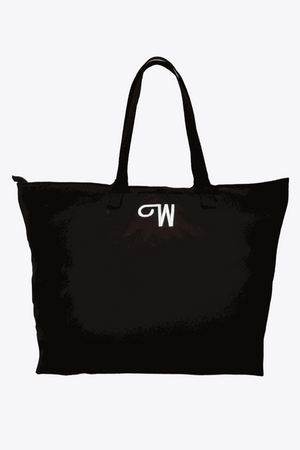 Black waterproof travel bag with sturdy handles and minimal design, spacious for everyday and travel use.