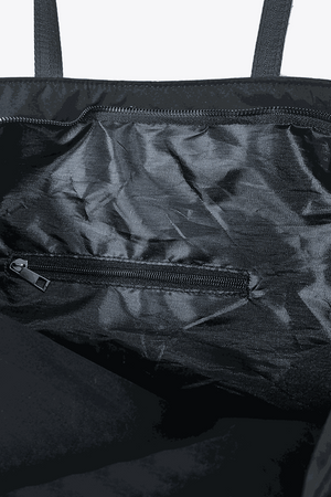 Interior view of black waterproof travel bag with zippered pockets and durable fabric lining