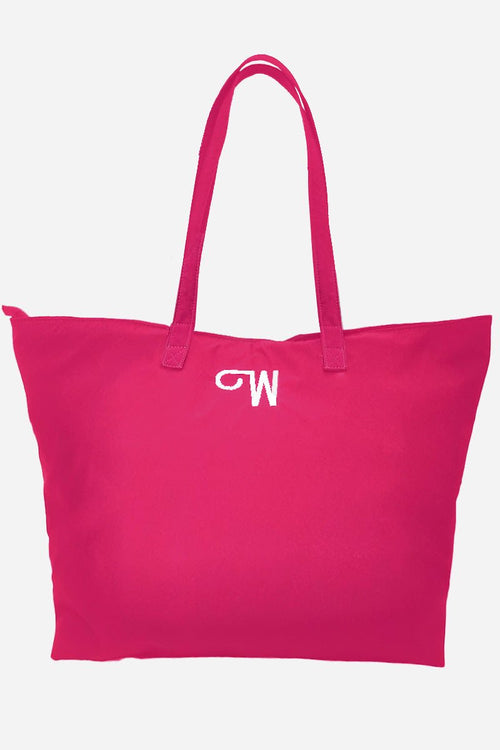 Red waterproof travel bag with long handles and embroidered logo, spacious and foldable design.