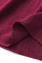 Close-up of lightweight burgundy fabric for high waist wide leg pants showing texture and softness