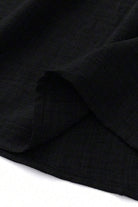Close-up of lightweight black fabric used for high waist wide leg pants