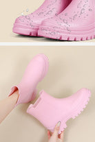 Pink non-slip rain boots with waterproof design and SuperGrip soles for enhanced traction and comfort