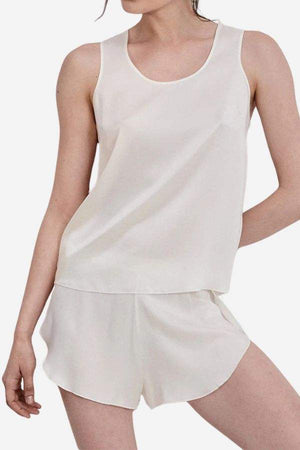 Woman wearing a cream-colored Mulberry Silk Tank & Shorts Set, lightweight and breathable sleepwear.