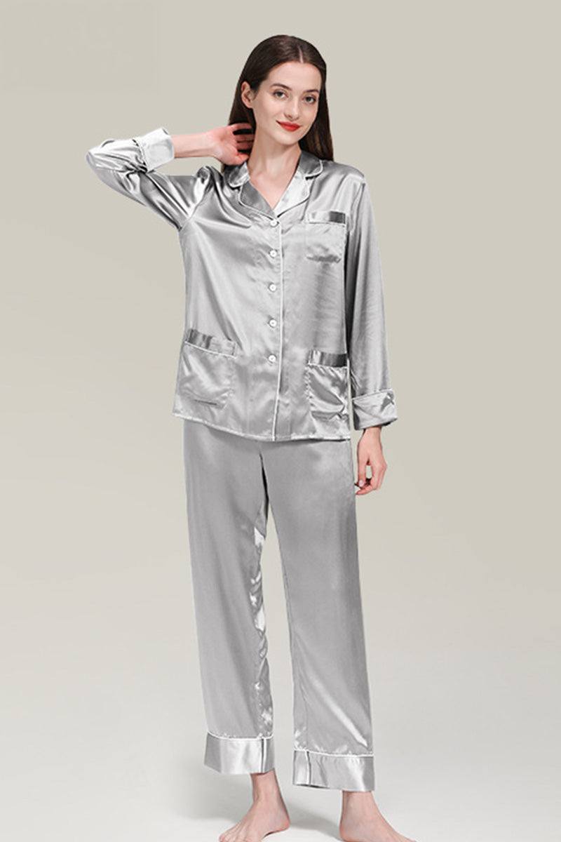 Woman wearing silver long sleeve silk pajamas button-up top and matching pants