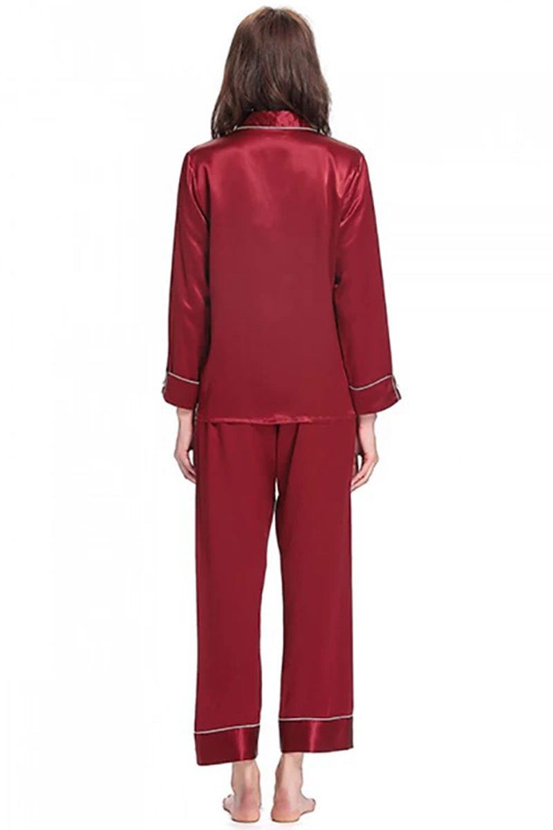 back view of woman wearing long sleeve silk pajamas set in deep red mulberry silk with button-up top and matching pants
