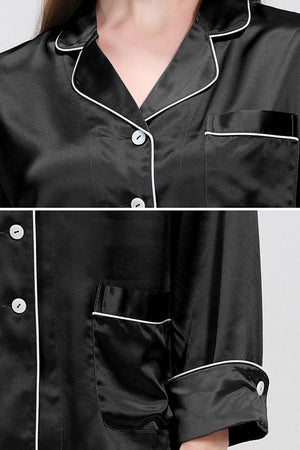 Black long sleeve silk pajamas with white piping and button-up front