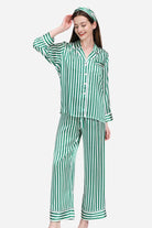 Woman wearing green and white striped 100% mulberry silk long sleeve pajama set with matching pants and headband