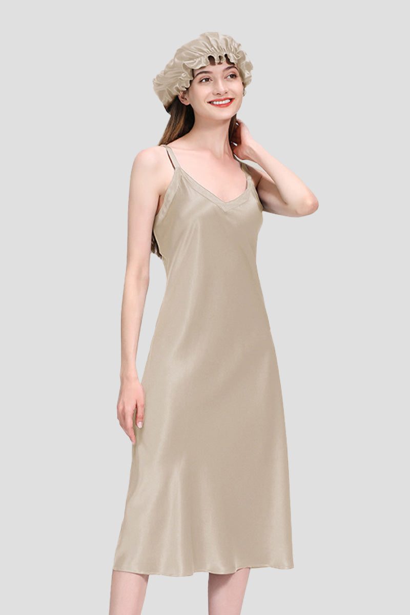 woman wearing beige mulberry silk elegant night dress and matching silk bonnet on gray background