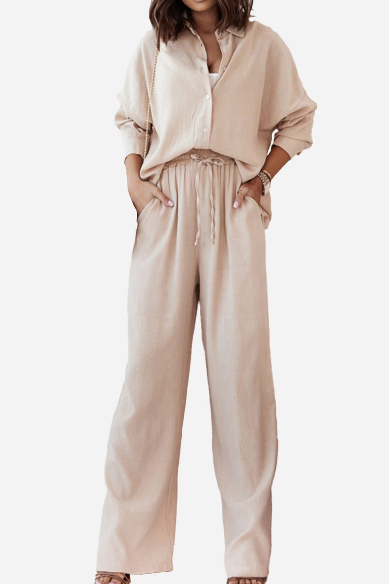Woman wearing beige professional and smart two-piece set with button-up shirt and wide-leg pants