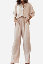 Beige casual two-piece set with loose shirt and wide-leg pants for a relaxed fit and professional look.